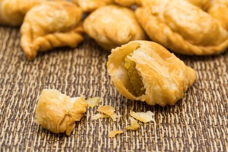 Delicious Curry Puffs on a dark matの写真素材