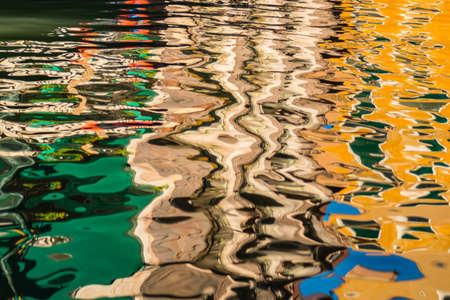 Ripples on the surface of water in narrow canal of Venice, Italyの写真素材