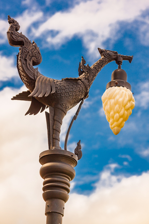 Swan with lantern on the city electric pole and blue skyの写真素材