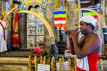 Kandy, Sri Lanka - July 18, 2011 : Dark skin man playing Horanewa in front of Tooth Sanctuary  in The Temple of Tooth Relic on the date of Perahera Festival in Kandy, Sri Lanka.のeditorial素材