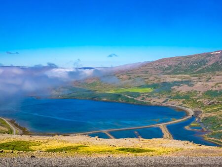 Aerial view of mountain roads and lake in Iceland in summerの写真素材