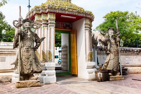 Stone carving giants infront of the gate of Wat Pho in Bangkok Thailandの写真素材