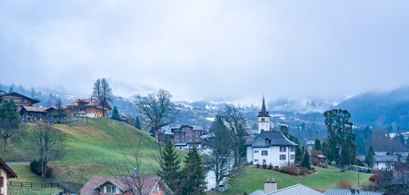 Panoramic view of Grindelwald Village in the morning with foggy alpine mountain after rain, Switzerlandの写真素材