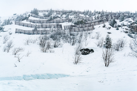 View of snow covered moutain with avalanche protection barrier in the snow day at Jungfrau, Switzerlandの写真素材