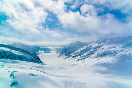 Panoramic view of the snowy Alps Mountain with the famous Aletsch Glacier at Jungfraujoch station in Switzerlandの写真素材