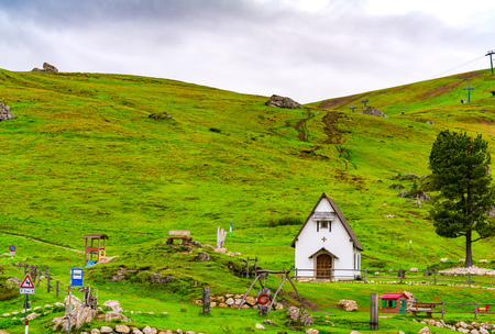 Small chapel at the Sella Pass of the Dolomites in South Tyrol Italy in cloudy dayの写真素材