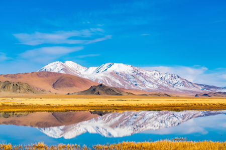 Beautiful landscape of Ulgii in western Mongolia with the river, the large yellow steppe and the beautiful mountainの写真素材