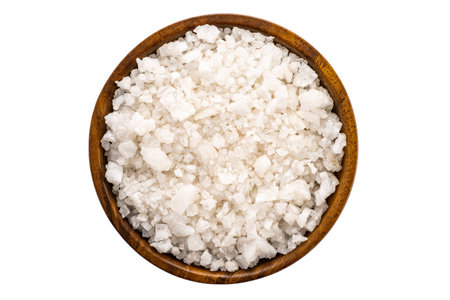 Top view of sea salt in wooden bowl on white backgroundの写真素材