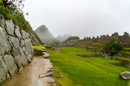 View of Rocks building, Terraces and green field are wet during the rain in Machu Picchu, Peru.の写真素材