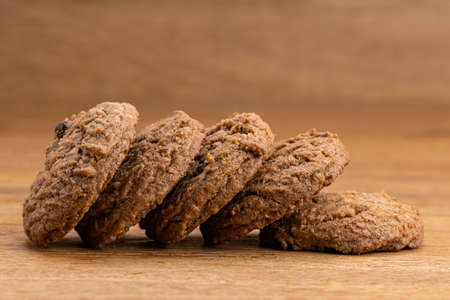 Closeup view pileof delicious homemade dessert snack chocolate chip butter cookies on wooden table.