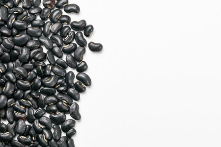 Top view of uncooked black beans on white background with copy space.の写真素材