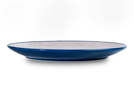 Side view of white and blue ceramic plate isolated on white background with clipping path.の写真素材