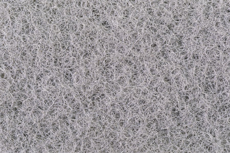 Macro view of texture surface of black kitchen scrubber sponge layer, background.