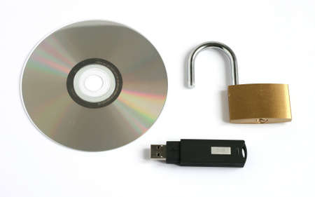 unlocked open padlock with usb memory stick and CD disk isolated on white backgroundの写真素材