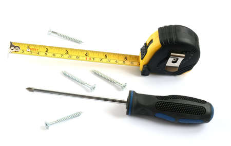 tape measure with screwdriver and screws isolated on white backgroundの写真素材