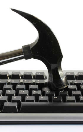 hammer striking a computer keyboard representing frustration or angerの写真素材