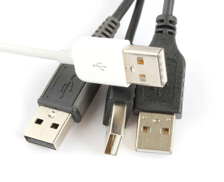 Multiple USB cables and plugs isolated on white backgroundの写真素材