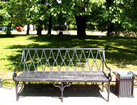 Bench by the path in the parkの写真素材