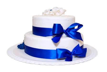 white wedding cake with blue ribbonsの写真素材