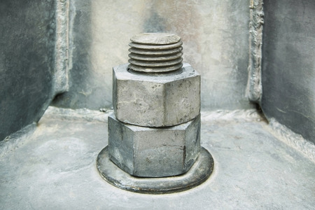 Two iron nuts on an iron backgroundの写真素材