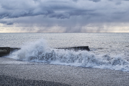 Seascape with a concrete pier during a storm in the rainの写真素材