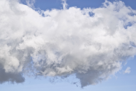 Ragged thick Cumulus cloud in blue sky