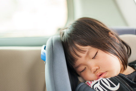 Children sleeping in the carの写真素材