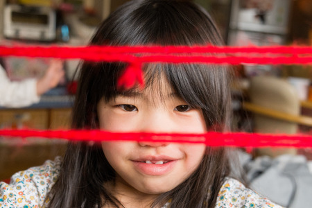 Children playing at the cat's cradleの写真素材