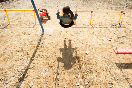 Girls playing on the swing