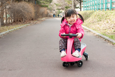 Children playing in the ride on toysの写真素材