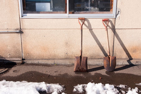 Shovel propped against the wallの写真素材