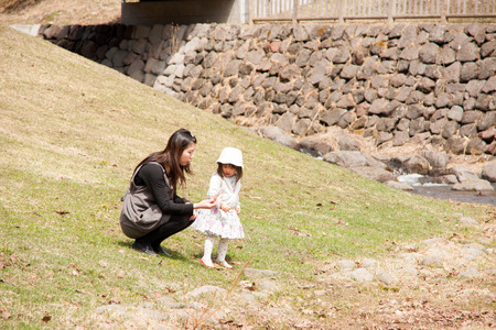 Parent and child playing in the riverの写真素材
