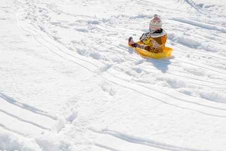 Children playing in a sledの写真素材