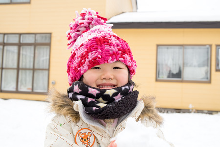 Children playing in the snowの写真素材