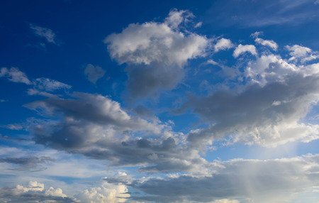 Sun shines through the rain clouds were gathering in the evening.の写真素材