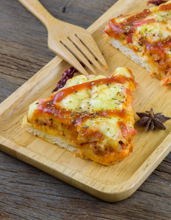 Crab Pizza cheese is placed on a wooden tray.の写真素材