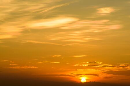 In the sky, the sun is about to set in the evening.の写真素材