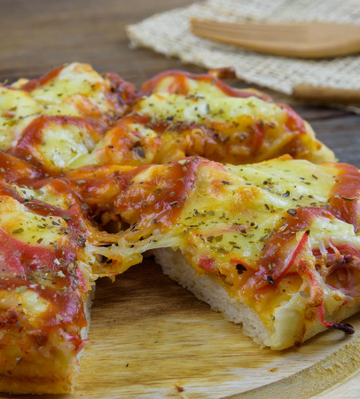 Crab Pizza cheese is placed on a wooden tray.の写真素材