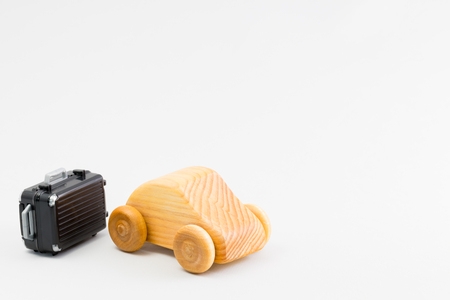 Wooden car and miniature of the suitcaseの写真素材