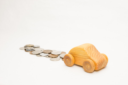 Wooden car and moneyの写真素材