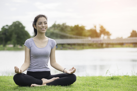 beatiful woman sitting yoga blackground riverの写真素材