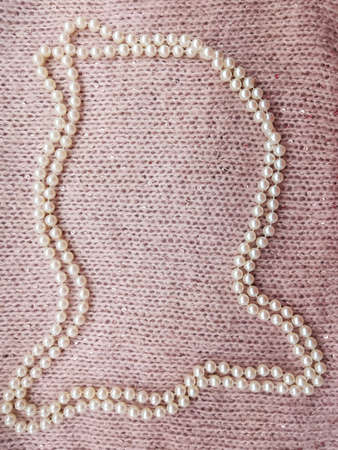 background soft thick woolen fabric of gentle pink color with small sequins with cones and white...