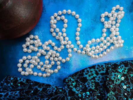 background blue with cosmetics jar of cream white and pearls whiteの写真素材