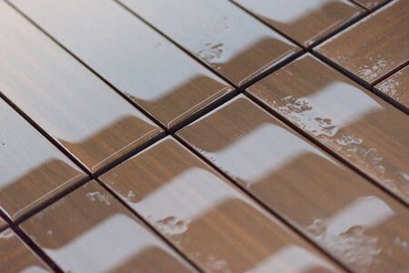 Wooden wet brown floor boards with waterの写真素材