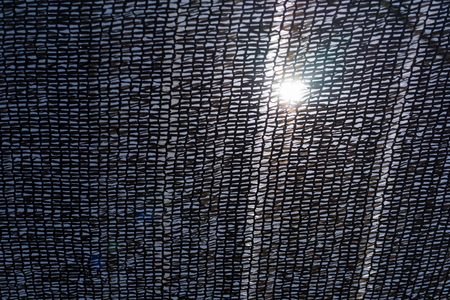 The bright sun through the old ship's grid