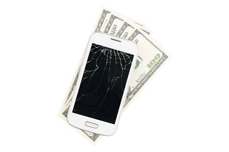 Broken white smartphone with many money in the isolated backgroundの写真素材