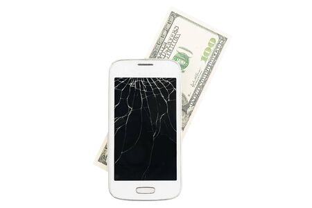 Broken white smartphone with money in the isolated backgroundの写真素材