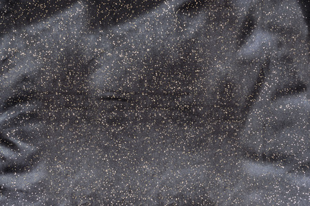Texture black fabric with yellow coating and foldsの写真素材