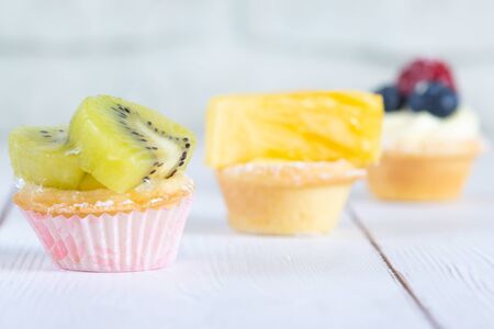 Fresh fruit tartlets on the wite table macroの写真素材