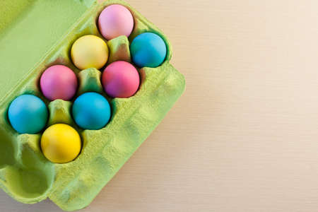 colorful painted easter eggs in green box